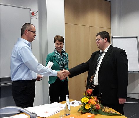 Markus Schürzeberg (links) und Petra Neuwirth (mitte) überreichen die Zertifikate.